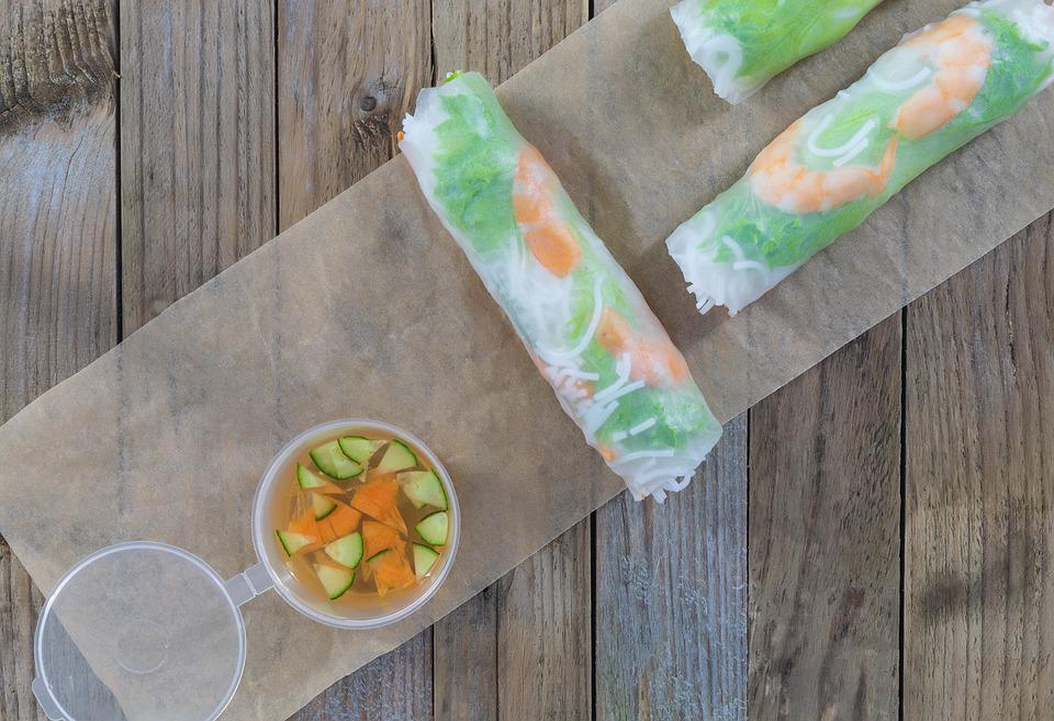 Spring rolls on cutting board with dipping sauce