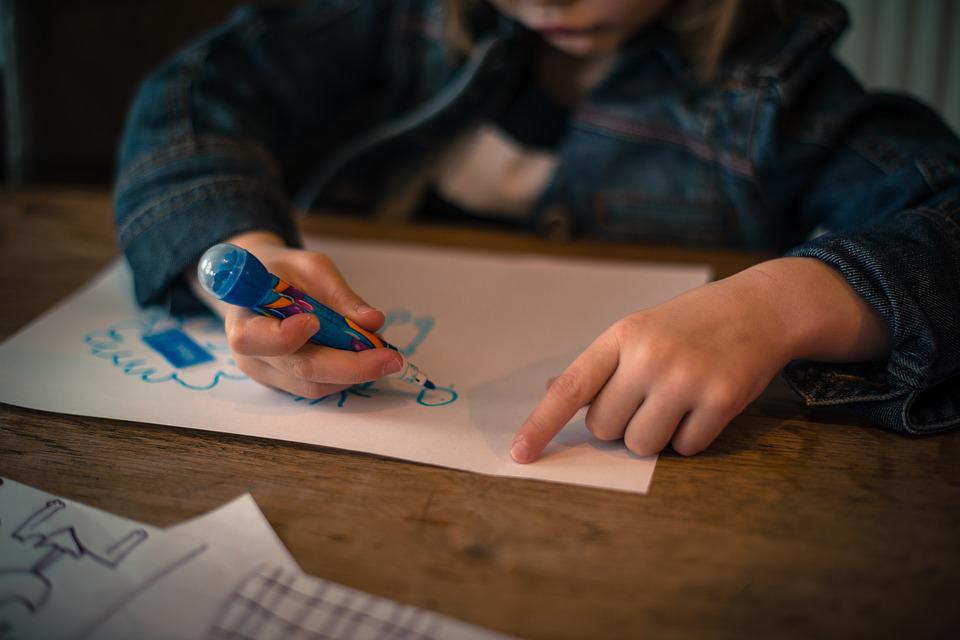 Child drawing on paper