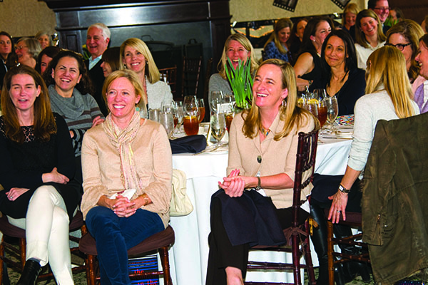 Smiling group of people sitting at tables