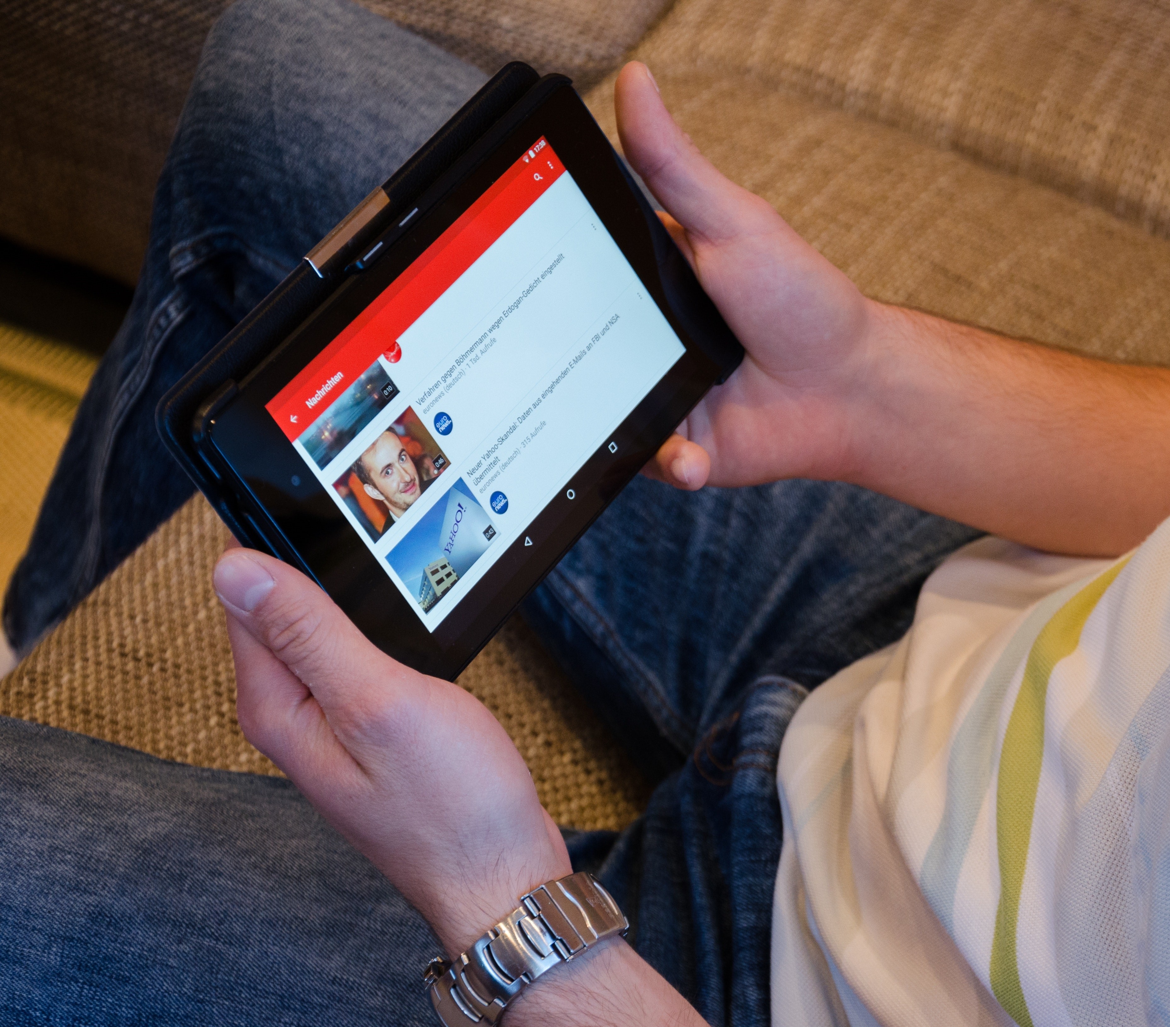 image of a person holding an ipad and scrolling through movies