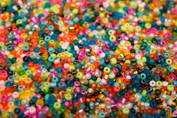 A pile of different colored seed beads
