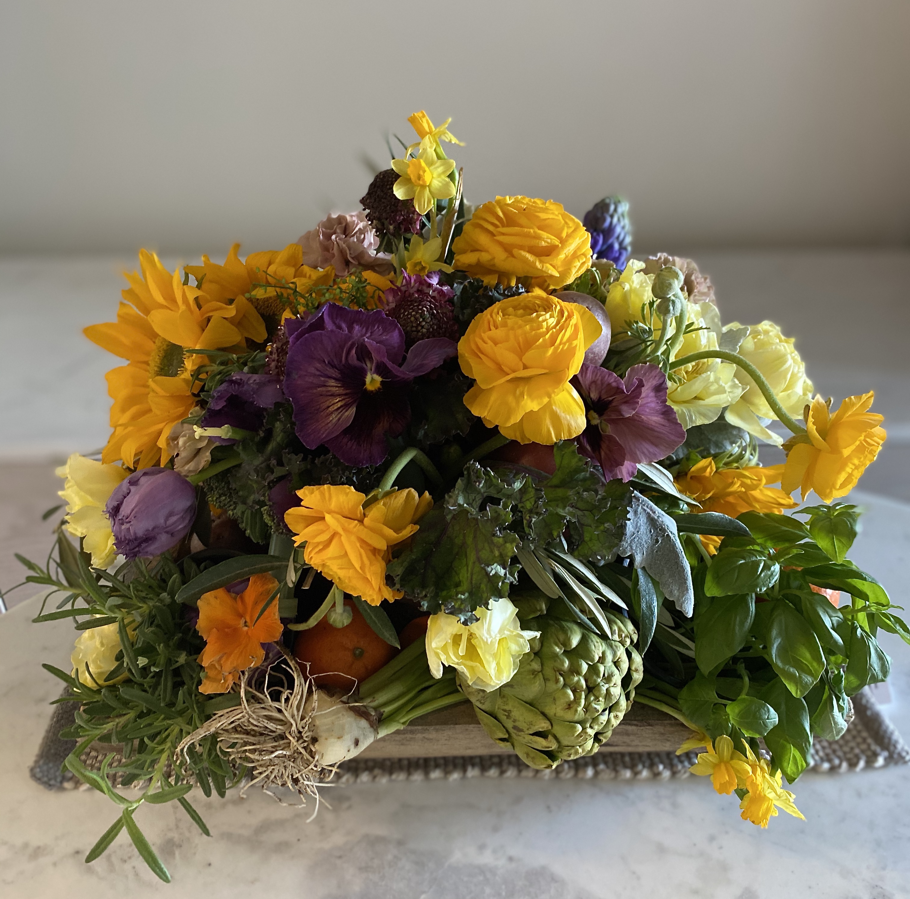 Spring floral arrangement with yellow and purple flowers. 