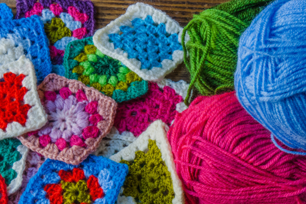 granny squares and 3 skeins of yarn