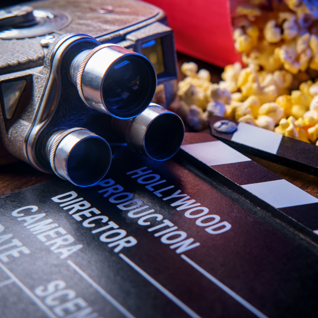 Vintage movie camera, clap board, and popcorn