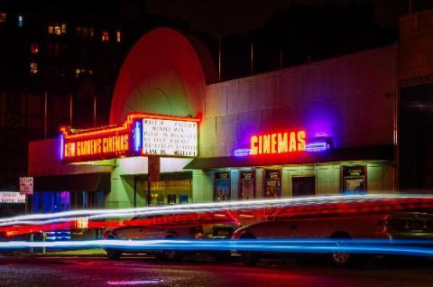 Movie cinema with marquee sign glowing in the night