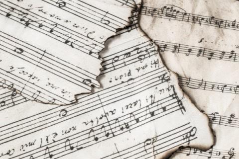 image of various pieces of sheet music layered on top of one another