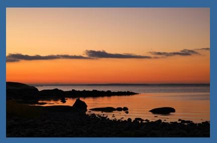 Image of a tranquil body of water at either sunrise or sunset