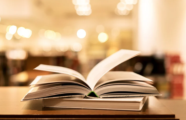 open book with twinkle lights in the background.