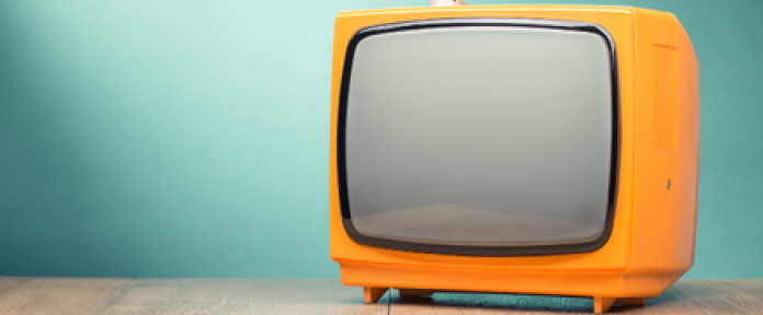 A photo of a yellow CRT TV.