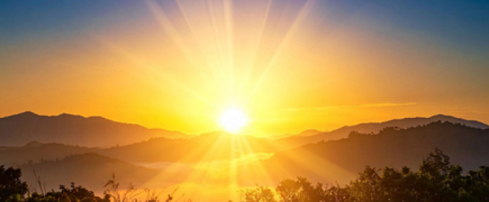 A photo of a sunrise over mountains